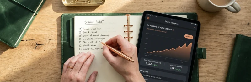 A tablet and planner showing a Pinterest board audit, comparing personal boards to a Pinterest group board strategy.